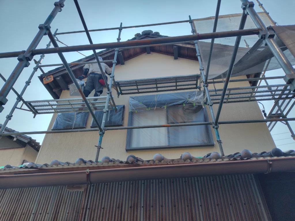 戸建住宅西側のサイディング外壁を塗装している様子